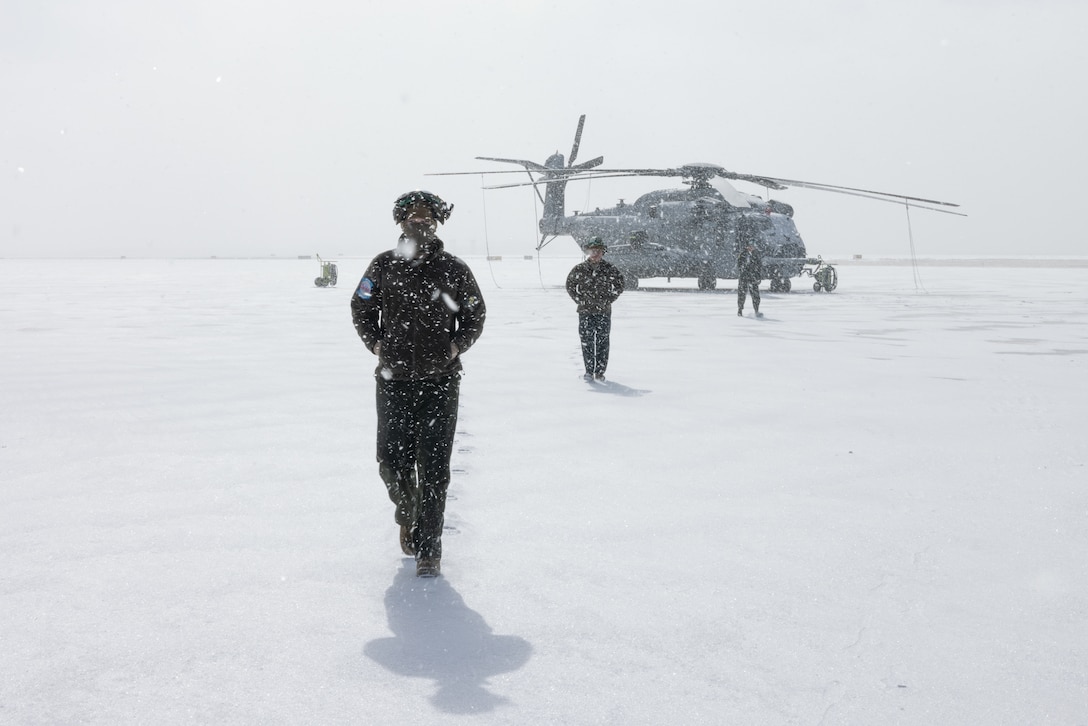 U.S. Marines with Marine Heavy Helicopter Squadron (HMH) 464 walk toward a hangar on Peterson Space Force Base, Colorado, Jan. 29, 2023. Marines with HMH-464 trained in a cold-weather, high-altitude environment to increase proficiency and improve overall combat readiness. HMH-464 is a subordinate unit of 2nd Marine Aircraft Wing, the aviation combat element of II Marine Expeditionary Force. (U.S. Marine Corps photo by Lance Cpl. Anakin Smith)