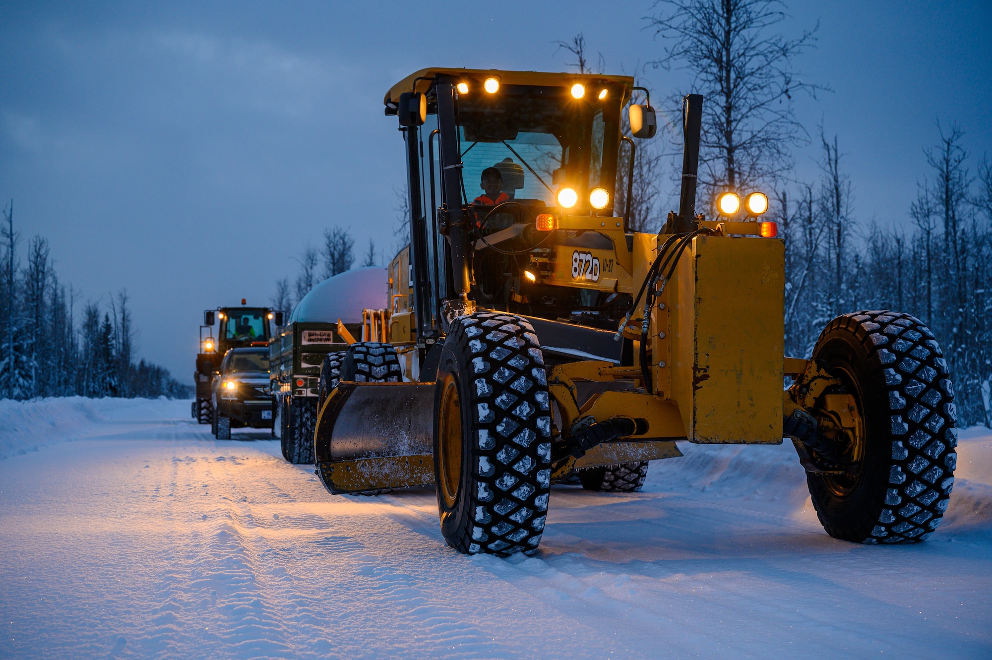 U.S. Airmen and personnel assigned to the 354th Range Squadron clear a trail at the Blair Lake Range Complex, Alaska, Jan. 26, 2023.