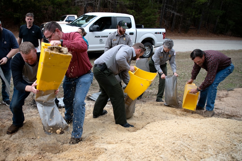 Mechanics, electricians, managers, specialists, and park rangers participate in a sandbag demonstration during dam safety training at the Richard B. Russell Dam on Feb. 1, 2023. USACE photo by Mel Orr.
