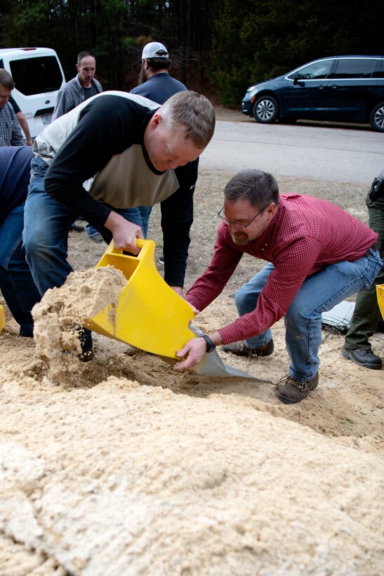 Jeremy Jones, left, electrician, and Timmy Thomas, hydroelectric power maintenance manager, participate in a sandbag demonstration during dam safety training at the Richard B. Russell Dam on Feb. 1, 2023. USACE photo by Mel Orr.