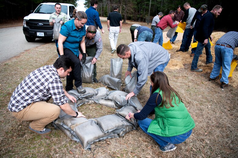 Mary Lawson, third from left, emergency management specialist, leads a sandbag demonstration for mechanics, electricians, managers, and park rangers at the Richard B. Russell Dam on Feb. 1 2023. USACE photo by Mel Orr.