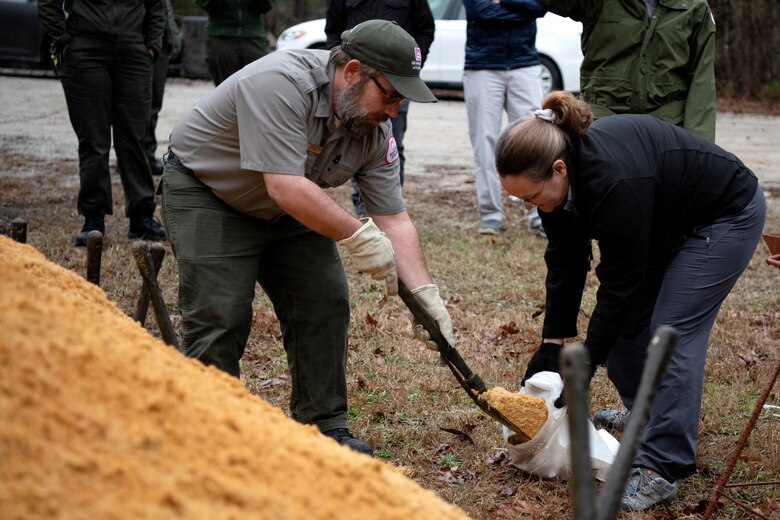 Josh Crocker, natural resource specialist, left, and Mary Lawson, emergency management specialist, participate in a sandbag demonstration during dam safety training at the J. Strom Thurmond Project on Feb. 2, 2023. USACE photo by Mel Orr.