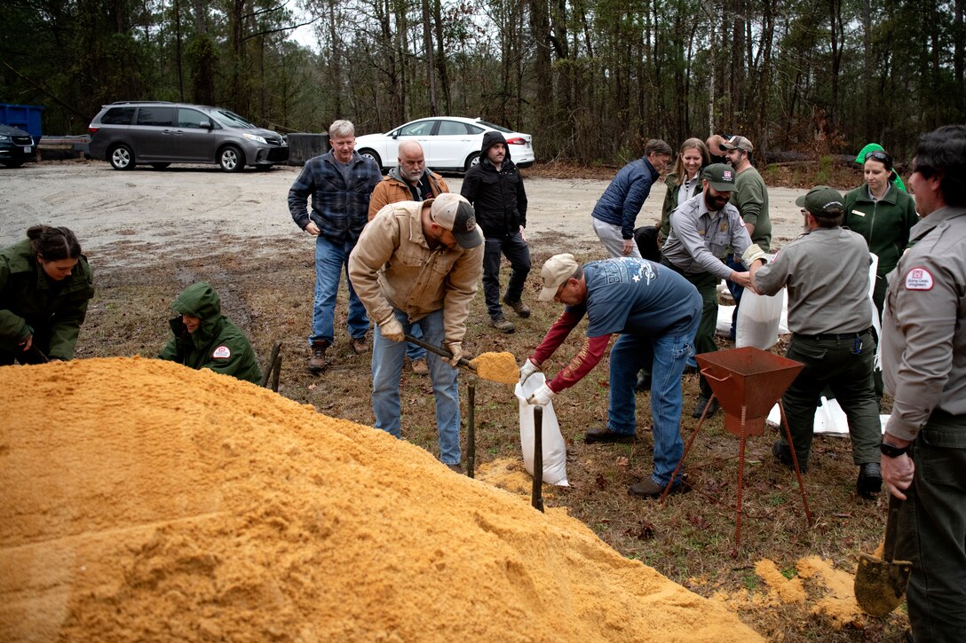 Mechanics, electricians, managers, specialists, and park rangers participate in a sandbag demonstration during dam safety training at the J. Strom Thurmond Project on Feb. 2, 2023. USACE photo by Mel Orr.
