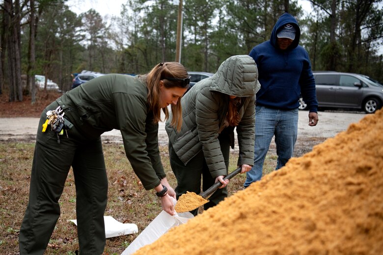Hannah Sue Hulpke, left, park ranger, and Makayla Barlow, park ranger participate in a sandbag demonstration while Elvie Jenkins, electrician, looks on during dam safety training at the J. Strom Thurmond Project on Feb. 2, 2023. USACE photo by Mel Orr.