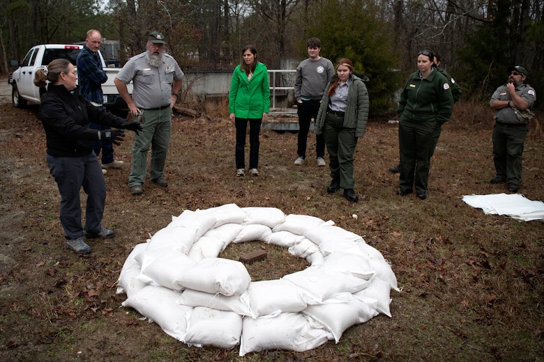 Mary Lawson, left, emergency management specialist, talks about the importance of flood-fighting techniques after a sandbag demonstration during dam safety training at the J. Strom Thurmond Project on Feb. 2, 2023. USACE photo by Mel Orr.