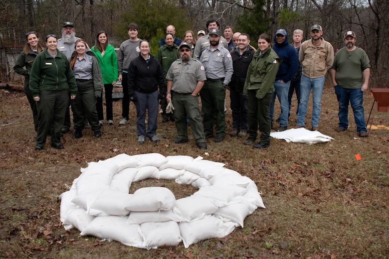 Personnel from the J. Strom Thurmond Project and the Savannah District home office pose for a group photo after a sandbag demonstration during dam safety training at the Thurmond Dam on Feb. 2, 2023. USACE photo by Mel Orr.