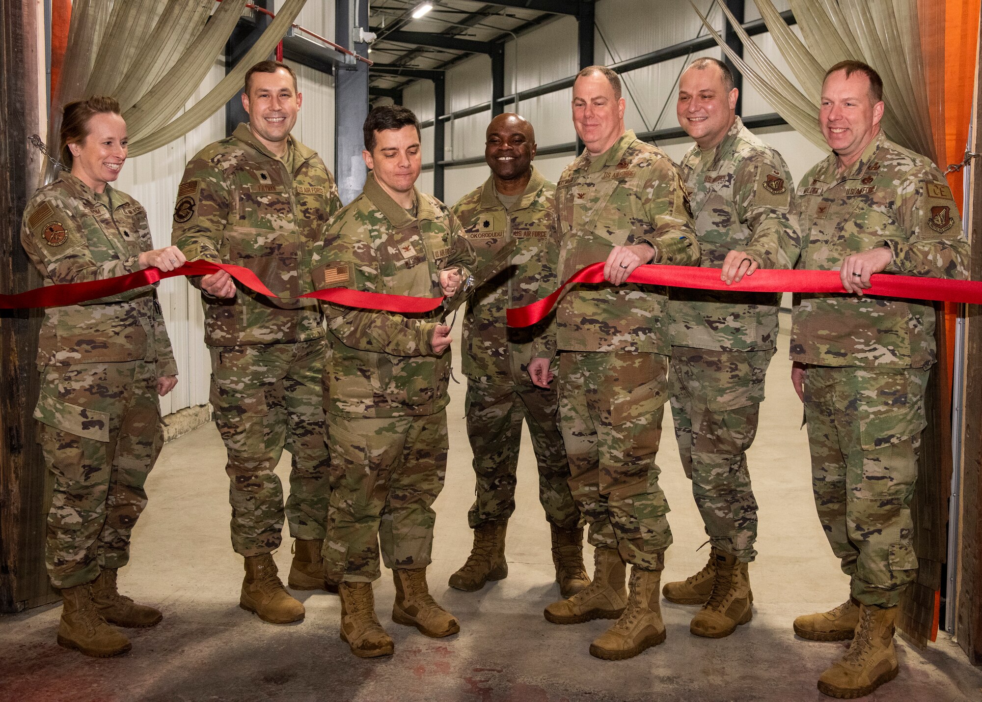 Joint Base Elmendorf-Richardson senior leadership commemorate the opening of a supply tunnel at Joint Base Elmendorf-Richardson, Alaska, Feb. 3, 2023. The $5.2 million project was designed to ease the warehousing and distribution of assets between the 673d Logistics Readiness Group and the 673d Medical Group, providing the ability to transport supplies and equipment from one warehouse to another without delay. (U.S. Air Force photo by Airman 1st Class Moises Vasquez)