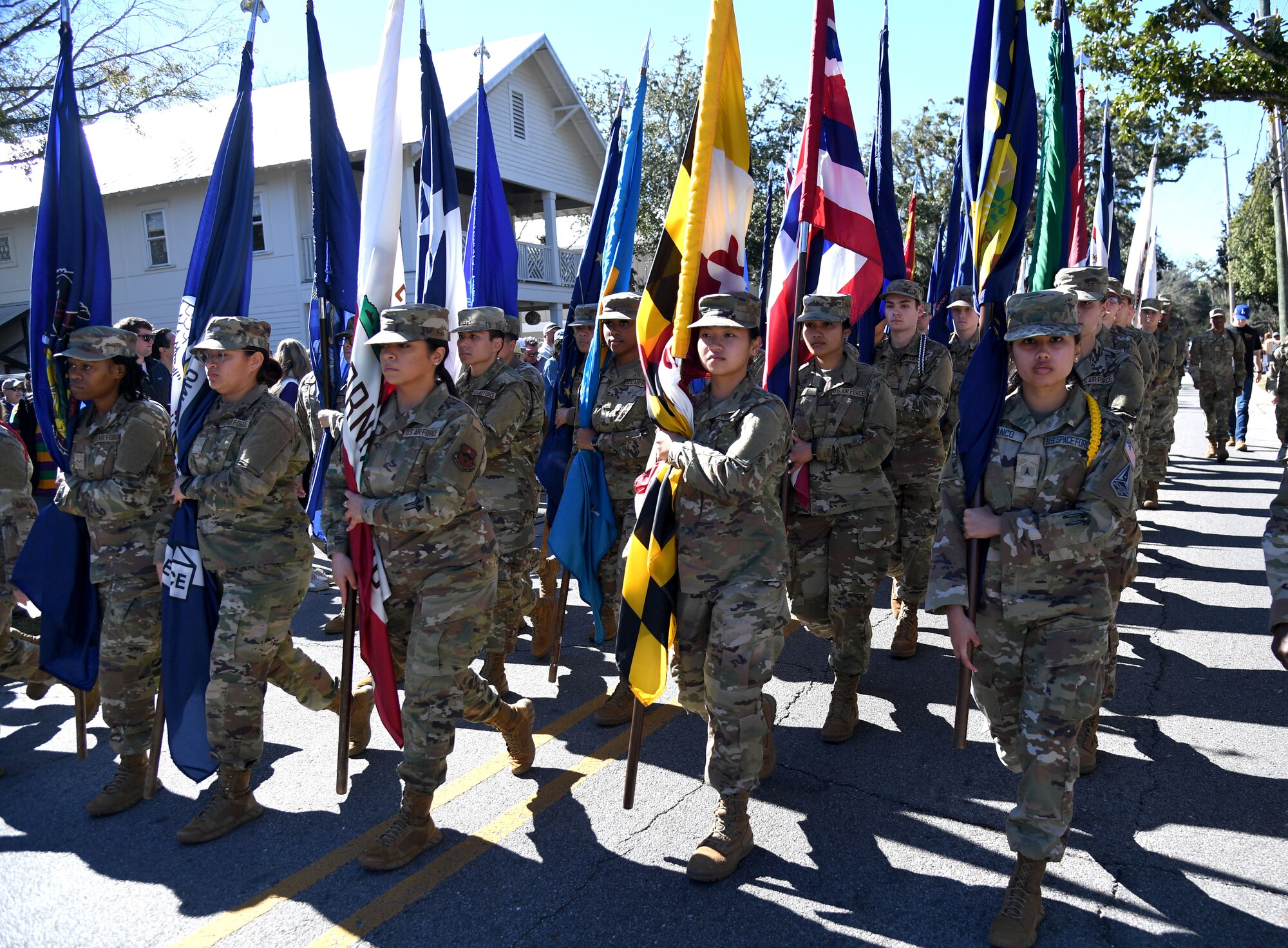 Keesler Air Force Base Airmen carry the 50 state flags during the Ocean Springs Elks Mardi Gras Parade at Ocean Springs, Mississippi, Feb. 4, 2023.