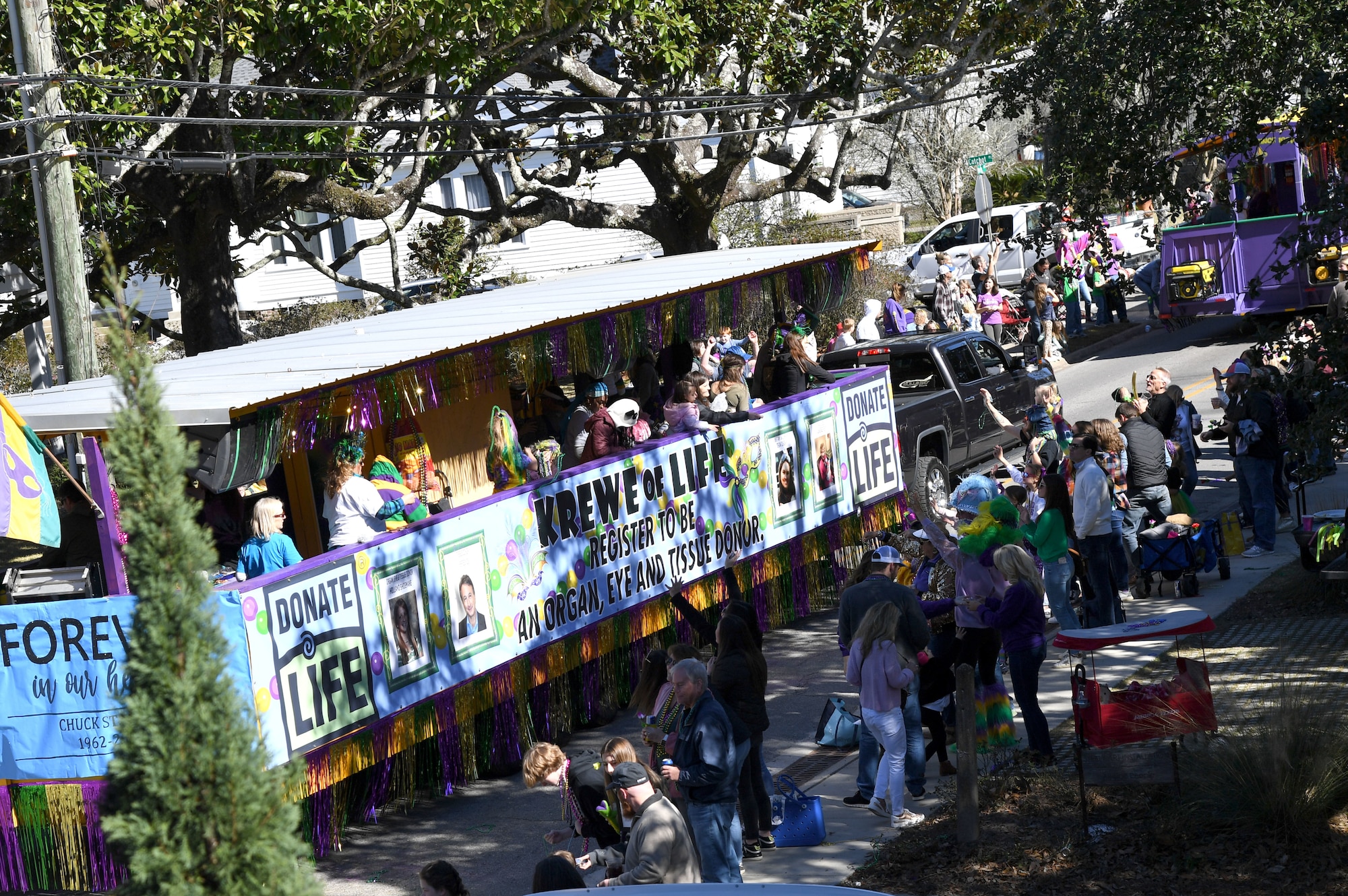 Floats ride by The Roost Boutique Hotel during the Ocean Springs Elks Mardi Gras Parade at Ocean Springs, Mississippi, Feb. 4, 2023.