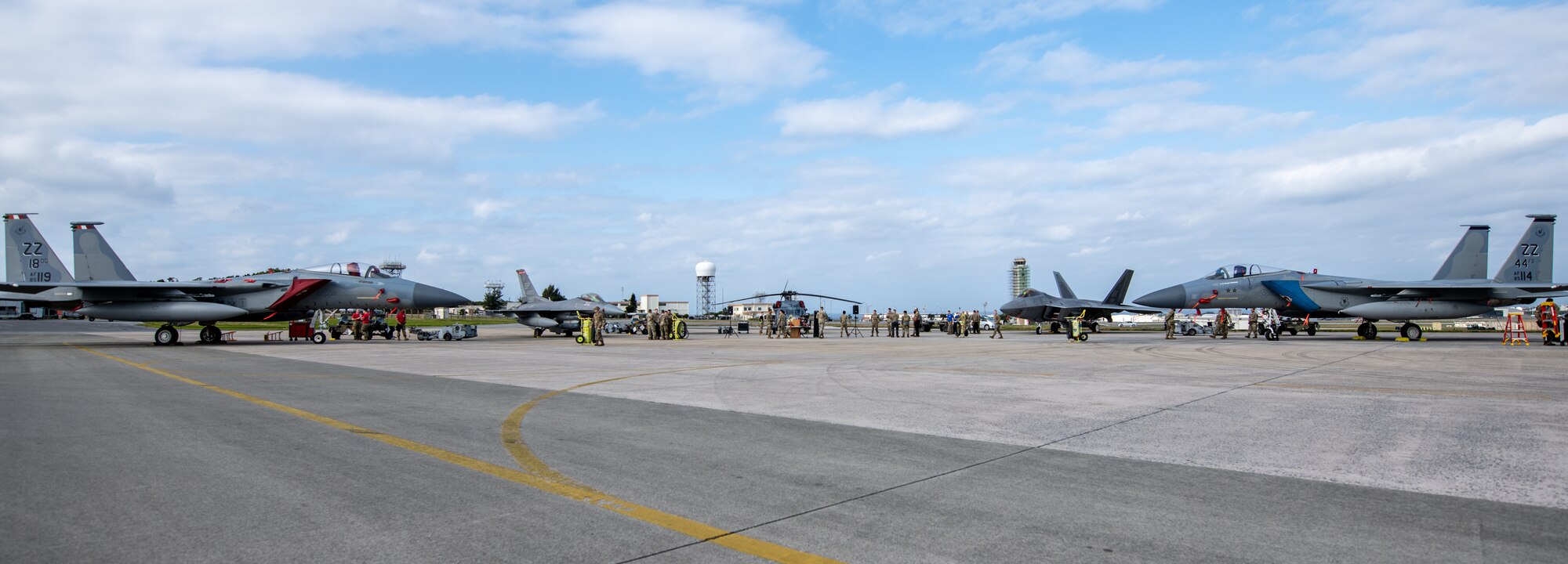 Jets and a helicopter are lined up.