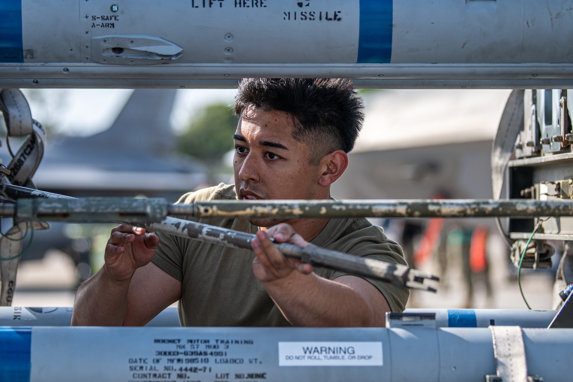 An Airman prepares missiles.