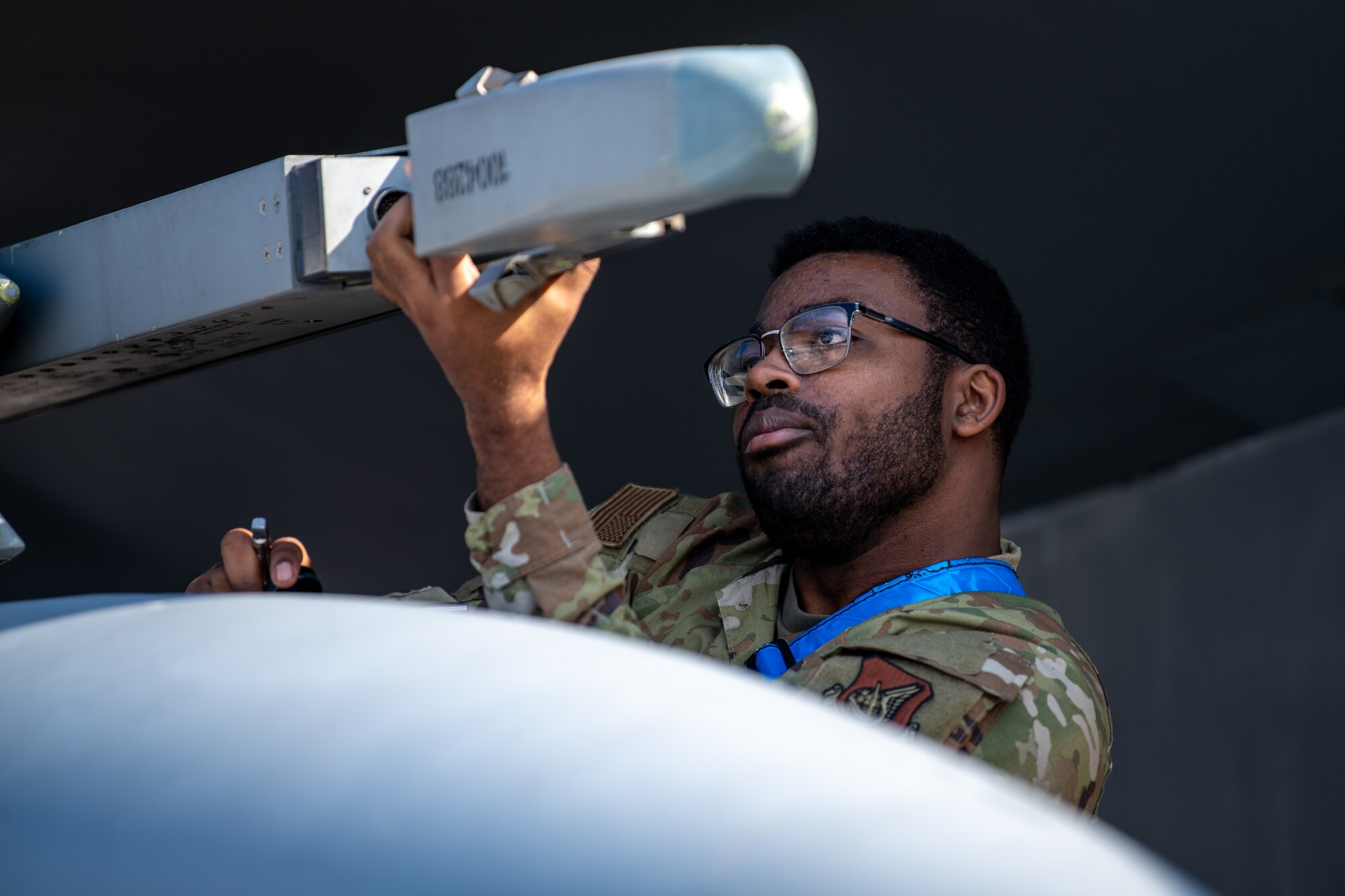 An Airman loads missiles onto a jet.