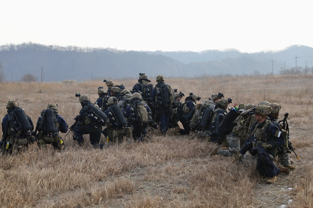 Soldiers from C Company, 2nd Battalion, 1st Infantry Regiment, 2nd Stryker Brigade Combat Team, 2nd Infantry Division exfiltrate from a CH-47F Chinook helicopter from B Company, 3rd Battalion, 2nd Aviation Regiment during large scale air assault training. A total of 130 Soldiers were transported in UH-60M Blackhawk and CH-47F Chinook helicopters.