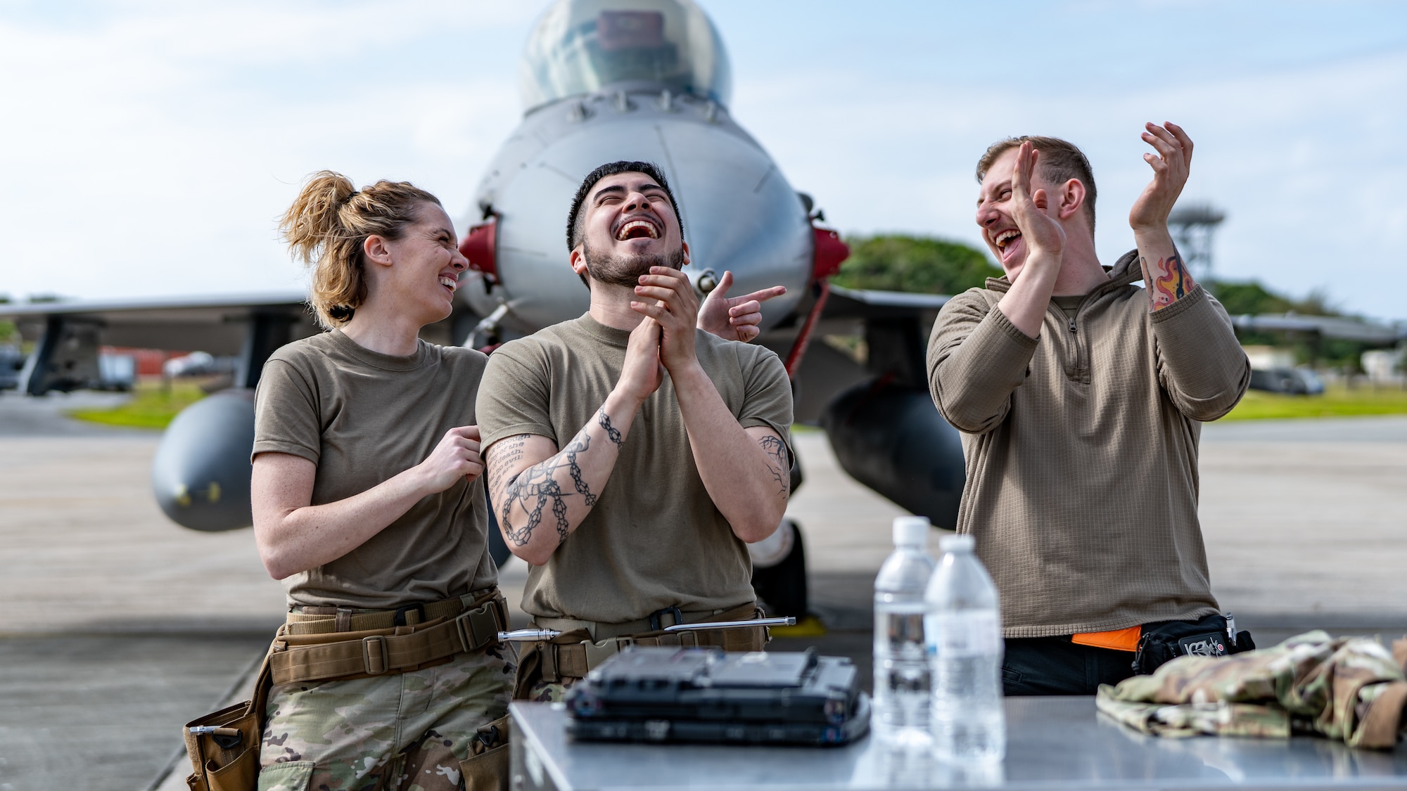 Airmen laugh together.