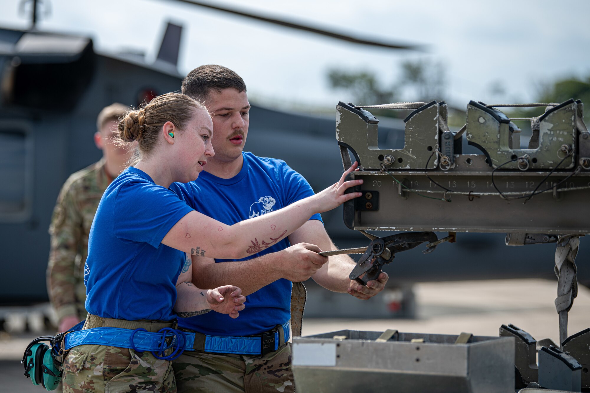 Airmen finish loading missiles.