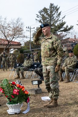 Brig. Gen. Mark Holler, Eighth Army deputy commanding general, operations, pays his respects with a salute during the annual Battle of Hill 180 ceremony at Osan Air Base, South Korea, Feb. 2, 2023.