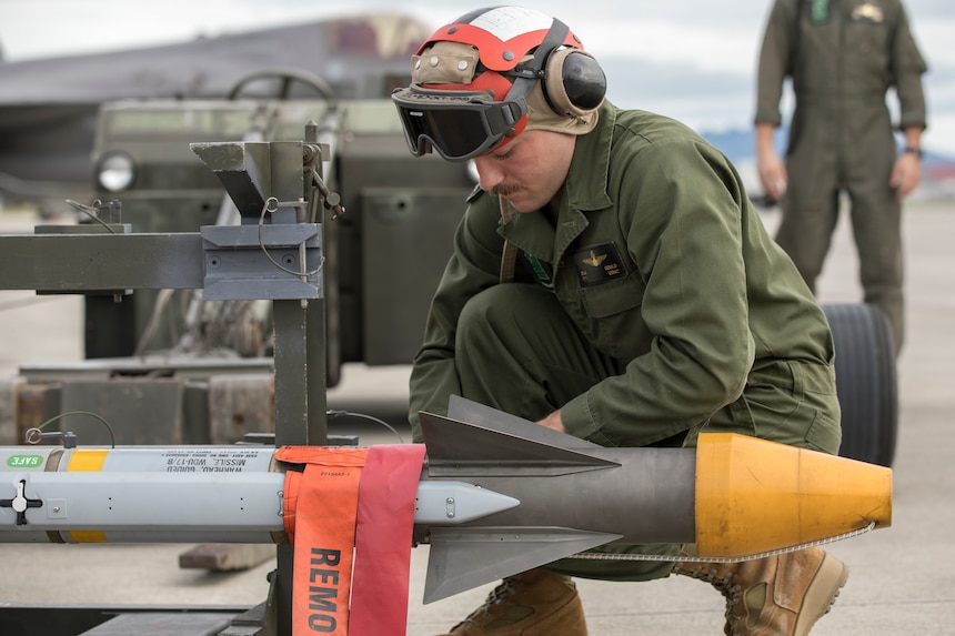 A Marine works on a missile.