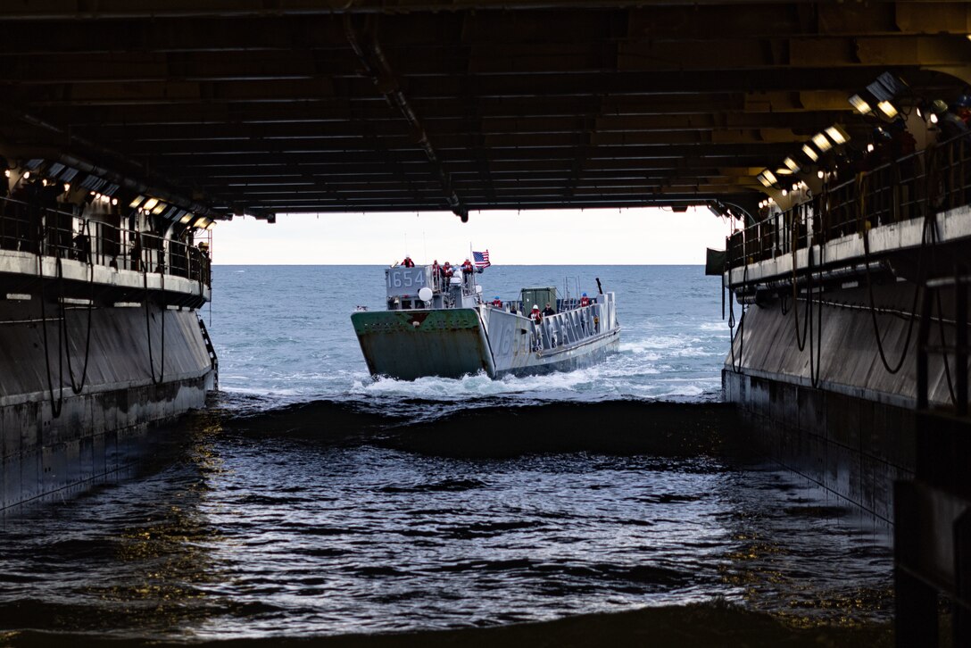 A U.S. Marine Corps Landing Craft Utility, assigned to the 26th Marine Expeditionary Unit (MEU), boards the Wasp-Class Amphibious Assault Ship USS Bataan  while underway during Amphibious Squadron/MEU Integrated Training , Jan. 23, 2023. PMINT is the first at-sea period in the intermediate stage of the MEU’s Pre-deployment Training Program; it aims to increase interoperability and build relationships between Marines and Sailors.