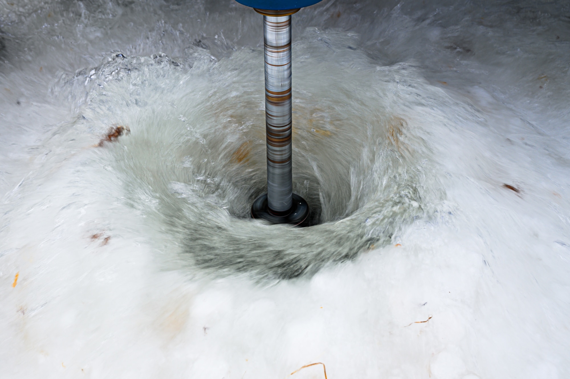 A BH-18 ice drill pumps out water from the ground at the Blair Lake Range Complex, Alaska, Jan. 26, 2023.