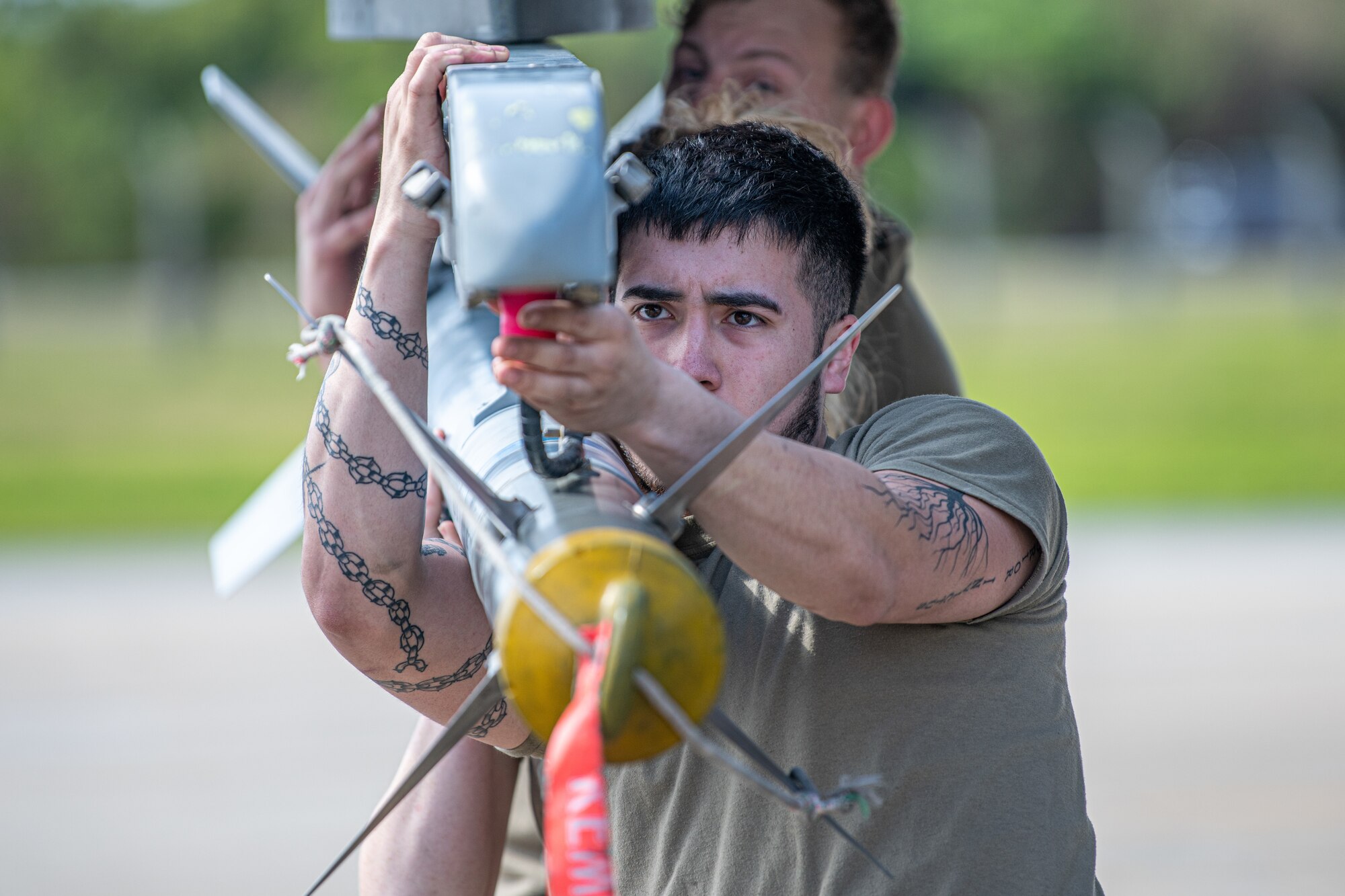Airmen attach a missile to a jet.