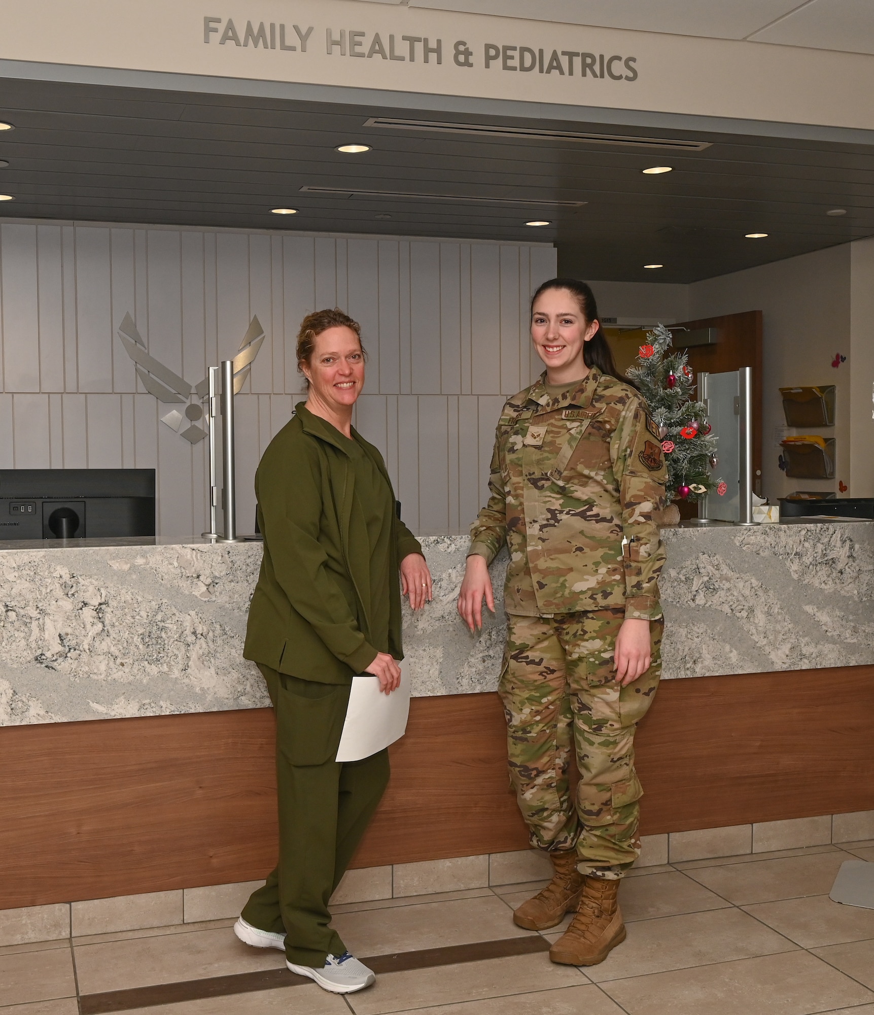 Major Vanessa North and Senior Airman Ashley French, 509th Medical Group, Women's Health Nurse Practitioner, posing for a photo at Whiteman Air Force Base, Janurary 18, 2023. The Women's Health Clinic provides services like birth control, pregnancy tests, and yearly check ups. (U.S. Air Force photo by Airman 1st Class Joseph Garcia)