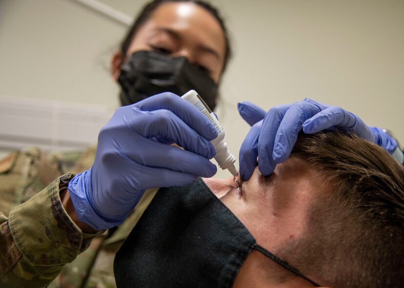 Airman 1st Class Samantha Sim, 59th Surgical Operations Squadron ophthalmic technician, administers numbing drops to a patient at the Ophthalmology Clinic in Wilford Hall Ambulatory Surgical Center, Joint Base San Antonio-Lackland, Jan. 19, 2023. The 59th SGC tests and treats to prevent vision loss, promote a better quality of life and support a worldwide qualified force. (U.S. Air Force photo by Senior Airman Melody Bordeaux)