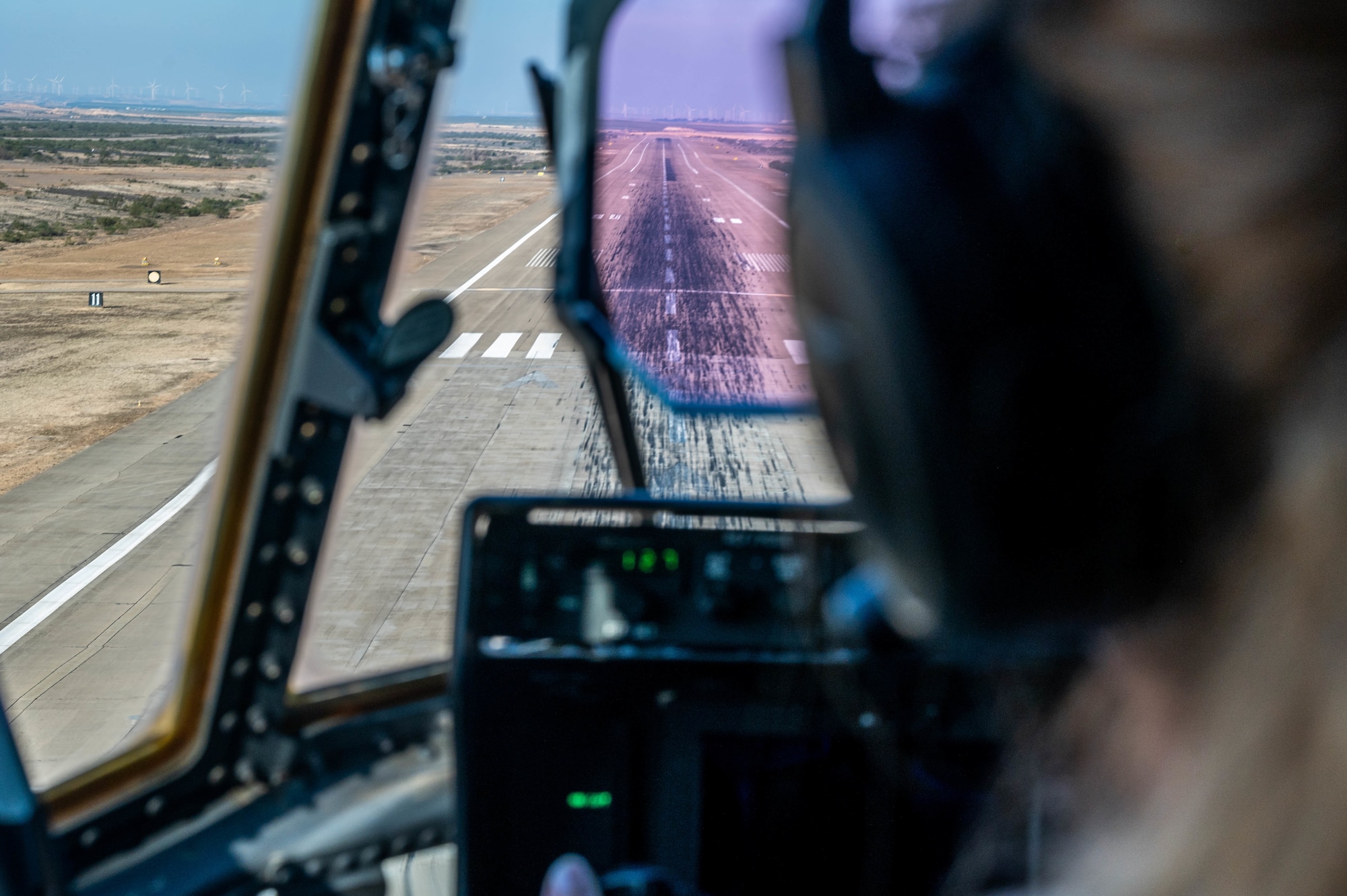 View of a flightline outside of a C-130J cockpit.