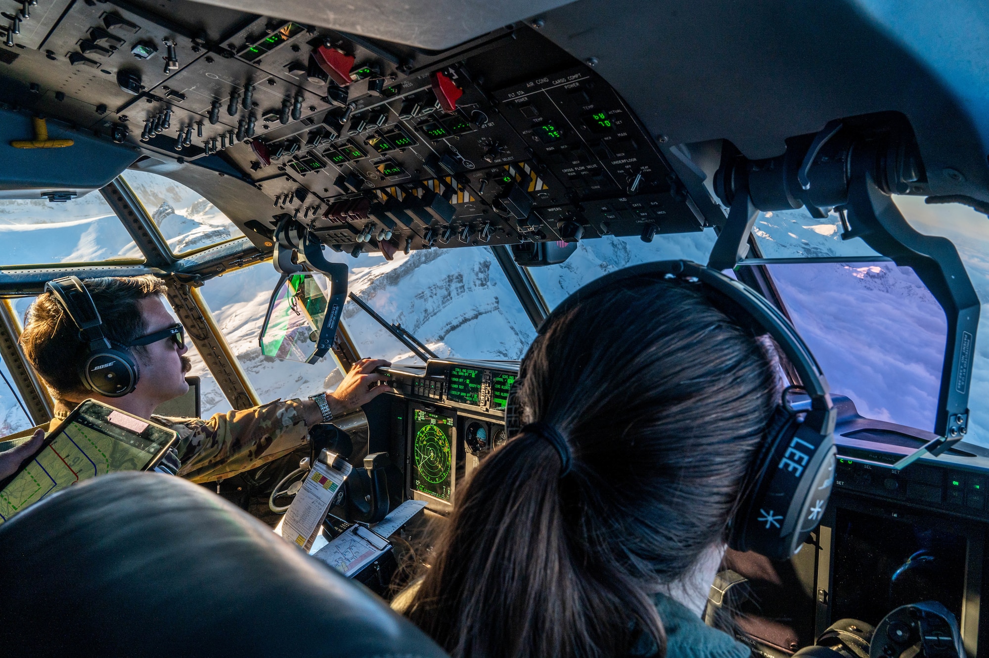 Two pilots fly a C-130J