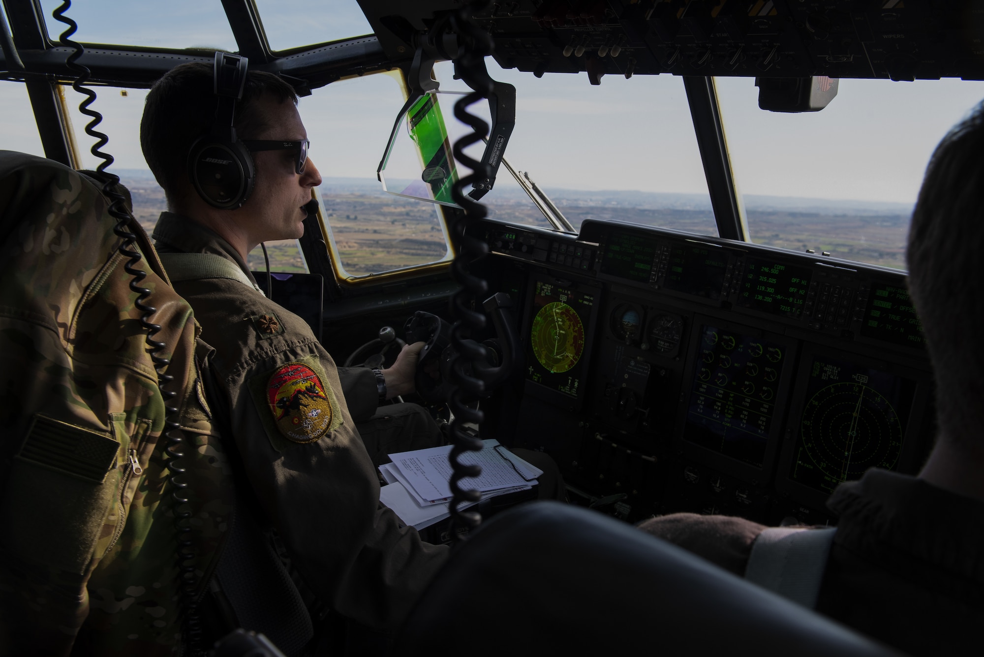 Pilot flies a C-130J inside cockpit