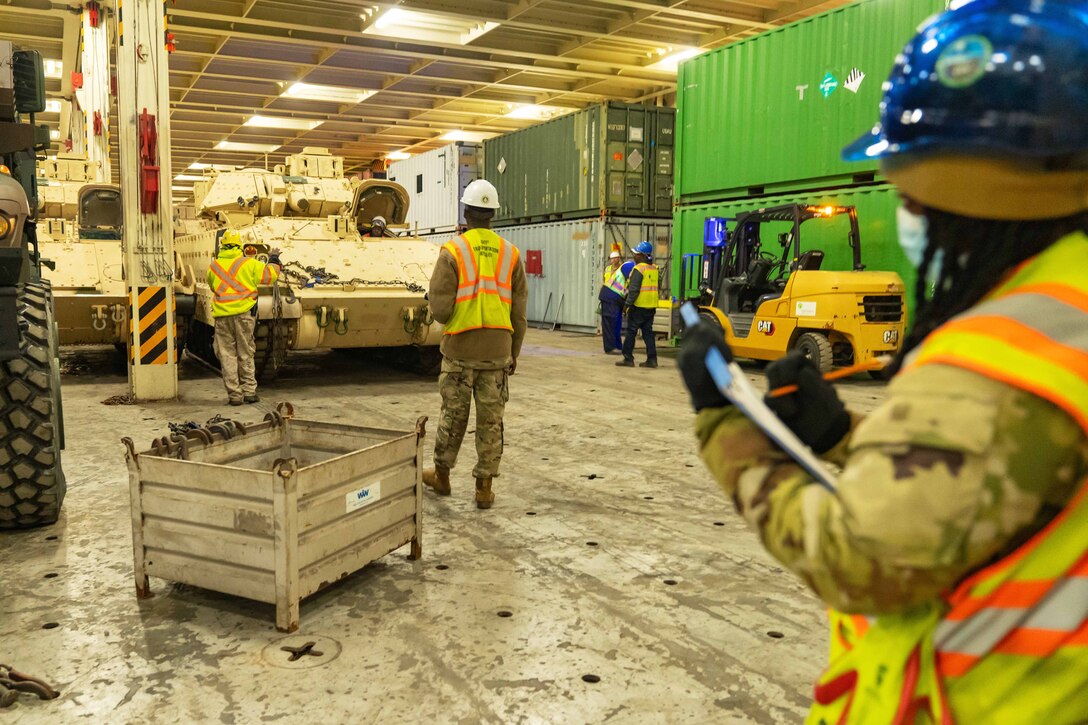Soldiers document and check a shipment of tanks.