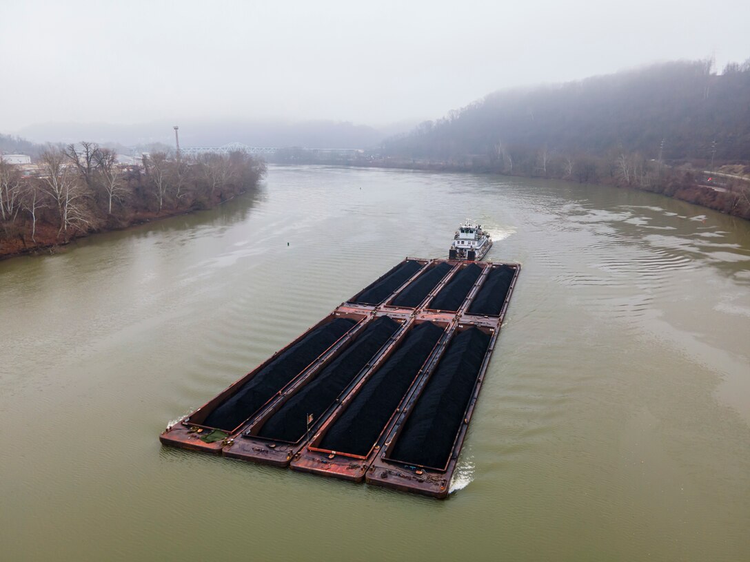 A towboat pushes eight barges of coal along the Monongahela River south of Pittsburgh, Jan. 30, 2023. Each barge can hold the same amount of material as 70 large semi-trucks or 16 rail cars. The U.S. Army Corps of Engineers Pittsburgh District operates 23 locks and dams on the Ohio, Monongahela, and Allegheny rivers, saving industries approximately $4 billion in transportation costs annually compared to using other means such as trucks or rail. The Pittsburgh District is known as the “Headwaters District” because the Ohio River starts at the point where the Allegheny and the Monongahela rivers converge. The Pittsburgh District offers the beginning of navigation for much of the nation, both geographically and historically. (U.S. Army Corps of Engineers Pittsburgh District photo by Michel Sauret)