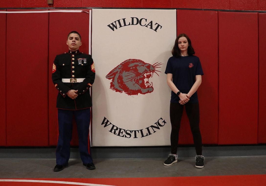 Poolee Marijane D. Huff, a Burlington, Kansas native, poses for a photo with her recruiter, Sgt. Alberto Figueroavidal, at Burlington High School, March 9, 2022. Huff, a state ranked wrestler and avid volunteer in her community, placed second in her state wrestling championship this year and is the second female wrestler in her school to win one hundred matches. Huff joined the Marine Corps Delayed entry program May 11, 2021 and is scheduled to depart for recruit training in June 2022.