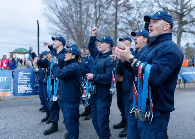 Members of Base Elizabeth City cheer on finishers of the inaugural Coast Guard Marathon March 6, 2022, in Elizabeth City, North Carolina. Runners will have completed 26.2 miles in a marathon. Base Elizabeth City provides a wide variety of mission support services to units and personnel, including general administration and personnel management, medical/dental, supply, procurement and warehousing, industrial services, facilities maintenance, computer/electronics support as well as morale and recreational services. Base Elizabeth City coordinates and provides regional mission support activities within the Fifth Coast Guard District. (US Coast Guard photo by Auxiliarist Andrew Winz)