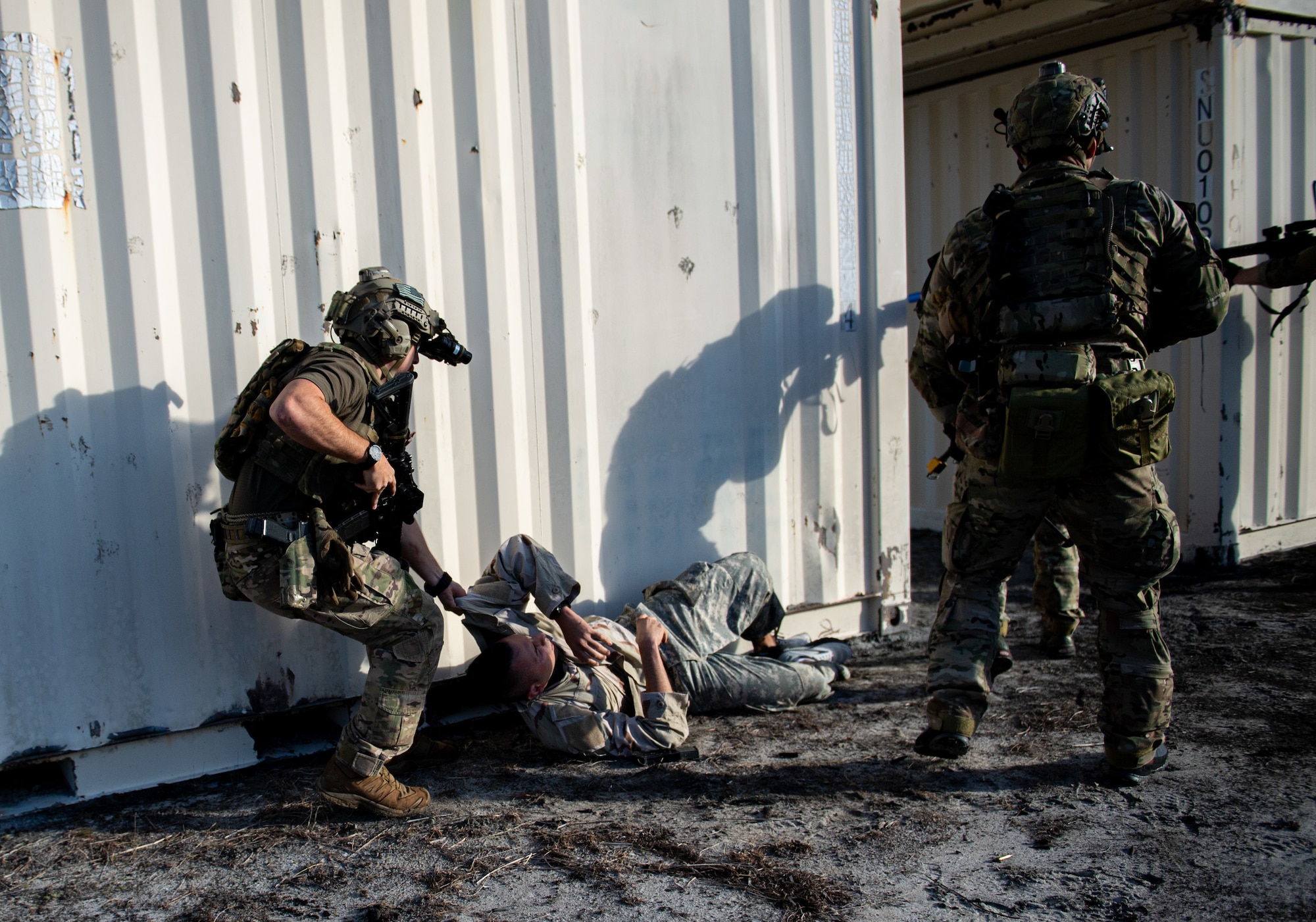 A photo of an Airman pulling a simulated patient to safety.