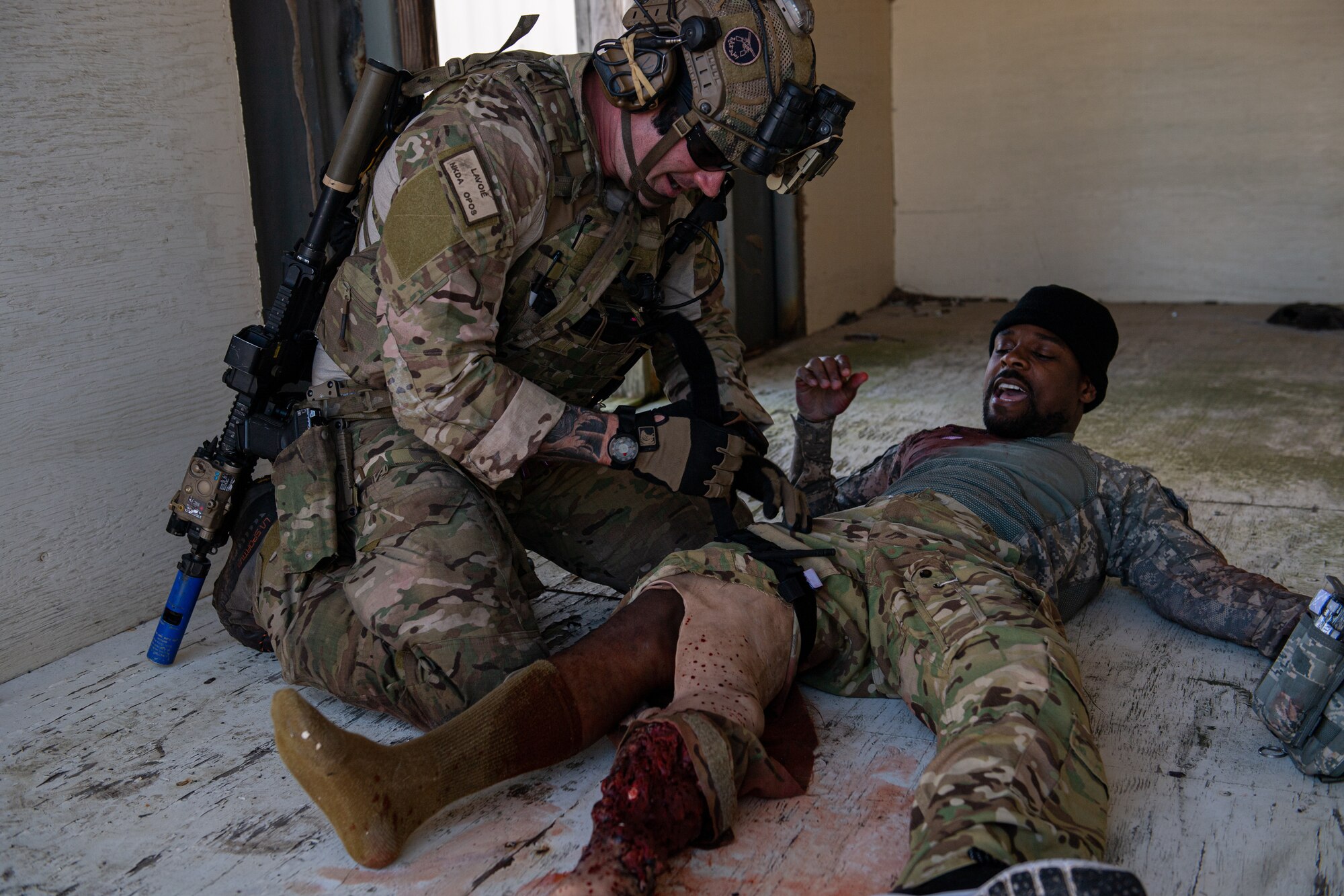 A photo of an Airman treating a simulated injured patient.