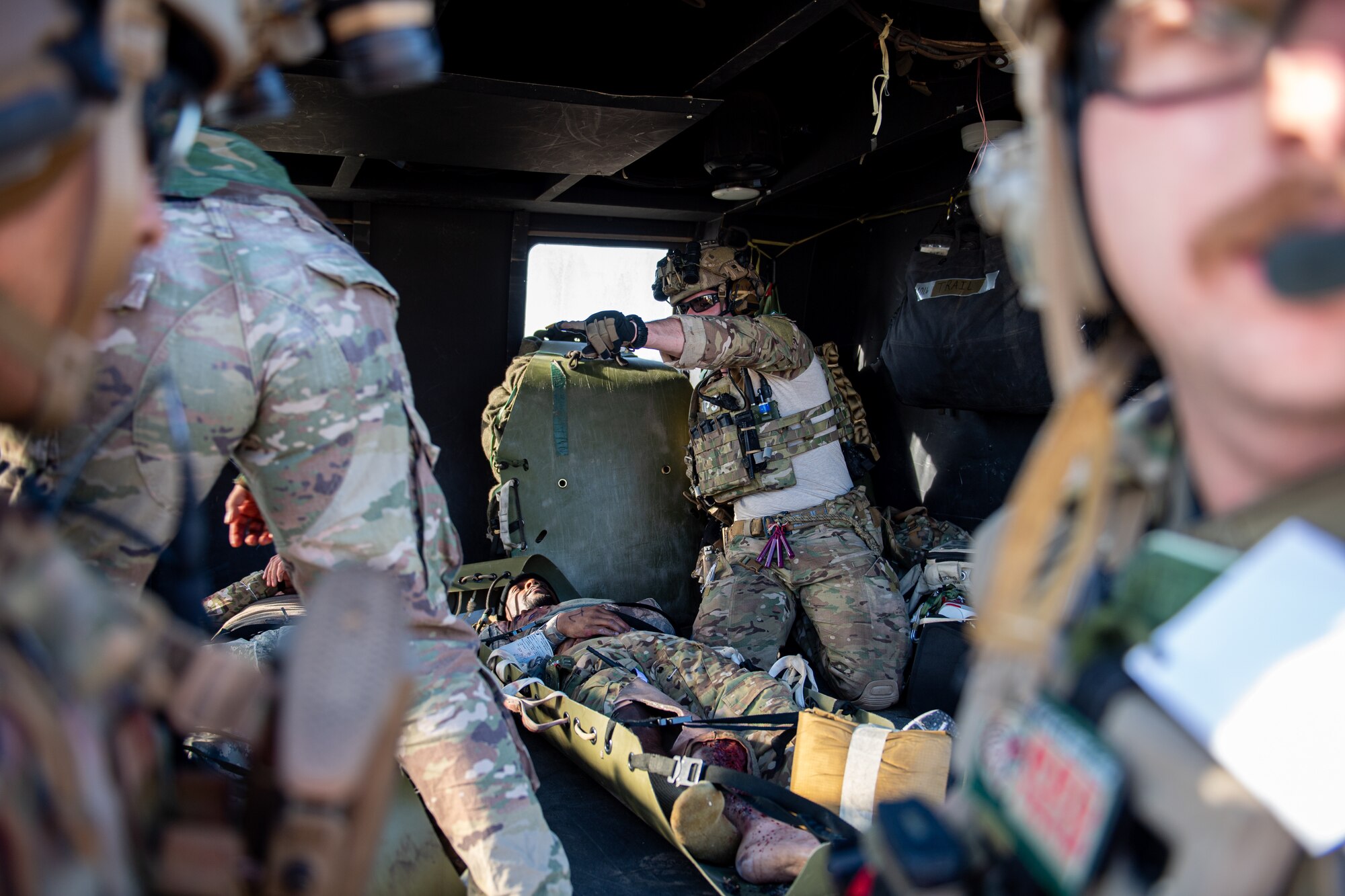 Airmen load a patient onto a simulated aeromedical evacuation.