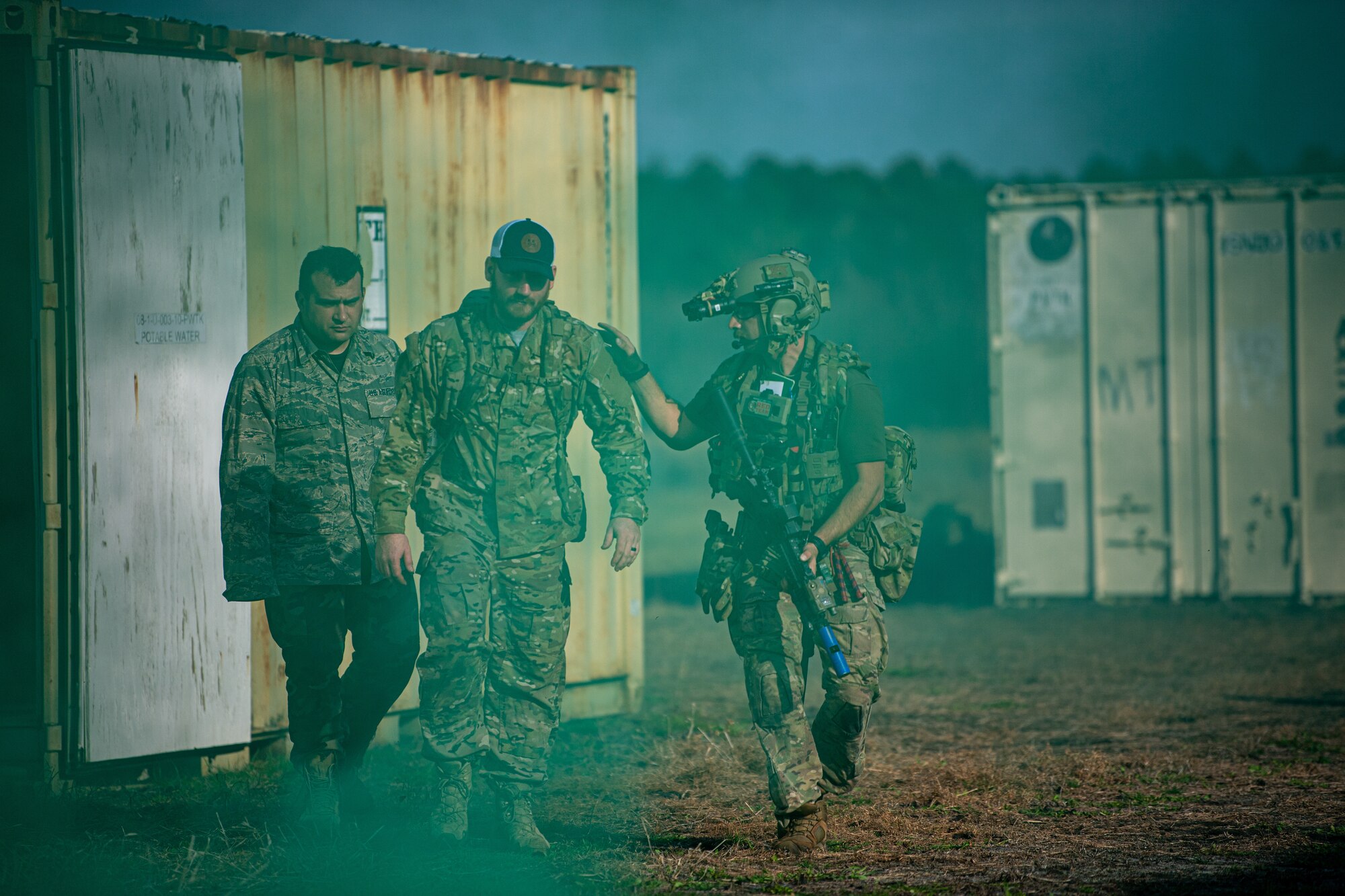 An Airman puts his hand on a patient while walking.