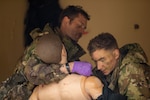 Sgt. Thomas Mulhern, left and Sgt. Klayton McCallum, members of the New York Army National Guard's 2nd Battalion, 108th Infantry, work on a simulated casualty during the Army Best Medic Competition at Fort Polk, Louisiana, Jan. 24, 2023.