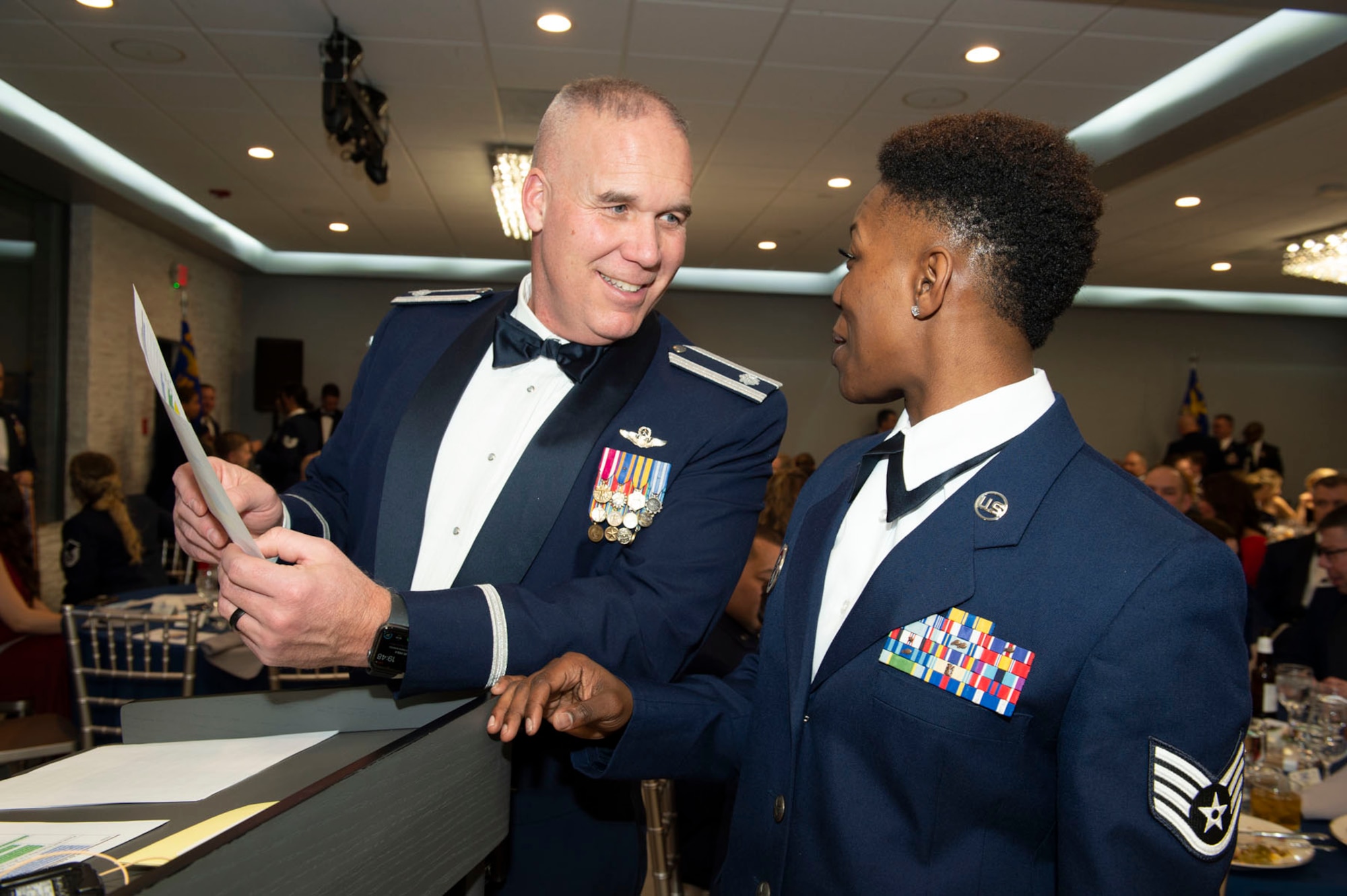 Lt. Col. Brian Thompson, 74th Air Refueling Squadron and Staff Sgt. Alexis Wilson, 434th ARW chaplain's assistant, go over the event schedule. The two served as the masters of ceremony for the 80th Anniversary Ball. Photo by Master Sgt. Rachel Barton.