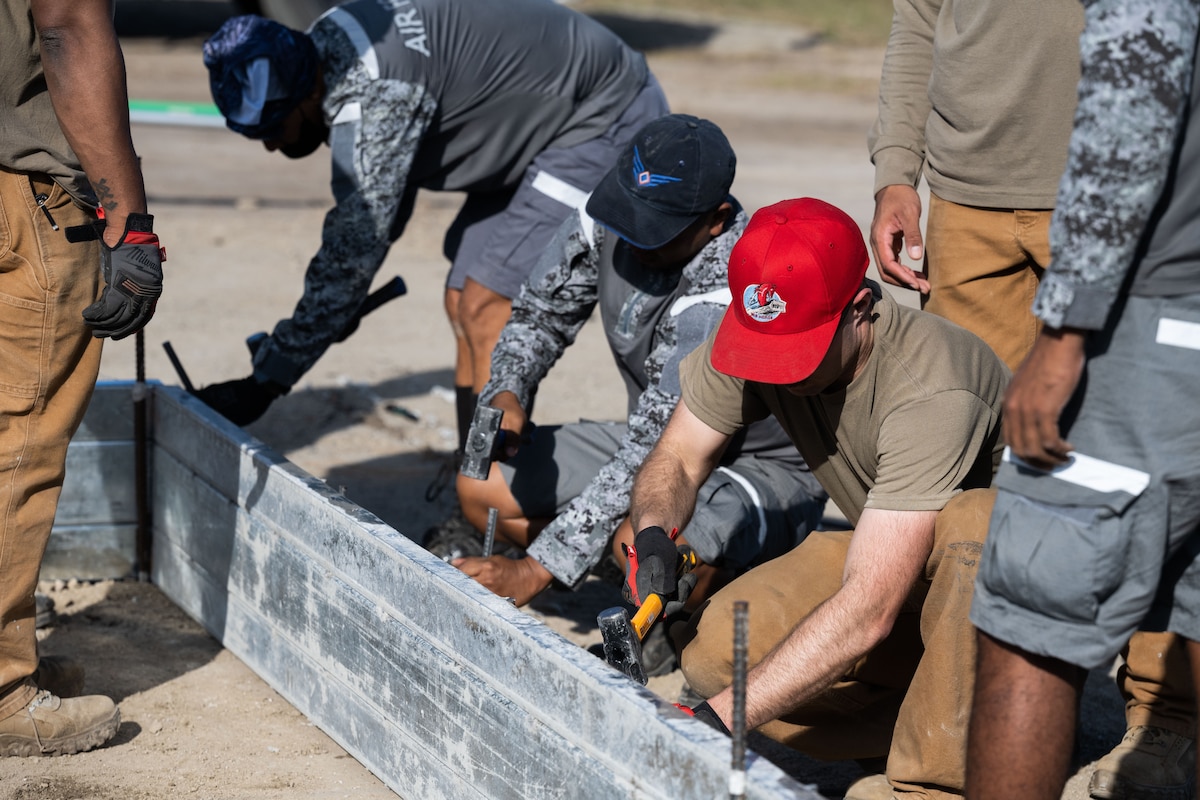 U.S. Air Force Staff Sgt. Derek Taft, 819th RED HORSE Squadron Pavements and Equipment operator, assembles forms with his Philippine Air Force counterparts to pour concrete at Basa Air Base, Philippines, January 25, 2023. Airmen from the 819th RED HORSE Squadron, out of Malmstrom Air Force Base, Montana, traveled to the Philippines and worked alongside their Philippine Air Force counterparts in a Field Training Event, Jan. 23 through Feb. 3. (U.S. Air Force photo by Tech. Sgt. Hailey Haux)