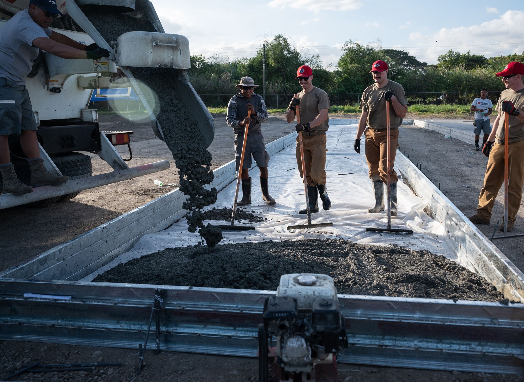 Airmen from the 819th RED HORSE Squadron out of Malmstrom Air Force Base, Montana, assist the Philippine Air Force in pouring concrete as part of a Field Training Event at Basa Air Base, Philippines, January 25, 2023. While the Airmen from the 819th were in the Philippines to pour concrete, they learned much more from their counterparts on and off the job. They shared special moments with each other including promotions, birthdays, culture, cuisine, and language. (U.S. Air Force photo by Tech. Sgt. Hailey Haux)