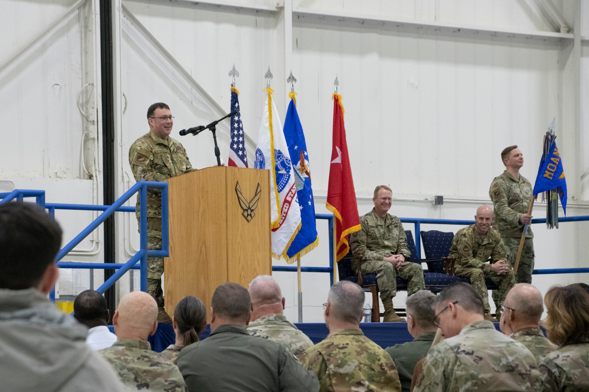 Col. Jared P. Kennish, 131st Bomb Wing commander, delivers remarks as Maj. Gen. Levon Cumpton, Adjutant General of the Missouri National Guard, and Col. Matthew D. Calhoun, outgoing 131st Bomb Wing commander, observe and Chief Master Sgt. Jason R. Henke, Command Chief Master Sergeant of the 131st Bomb Wing, bears the guidon during a change of command ceremony at Whiteman Air Force Base, Missouri, Feb. 3, 2023. During the ceremony Col. Jared P. Kennish assumed command of the 131st Bomb Wing from Col. Matthew D. Calhoun. (U.S. Air National Guard photo by Senior Airman Kelly C. Ferguson)