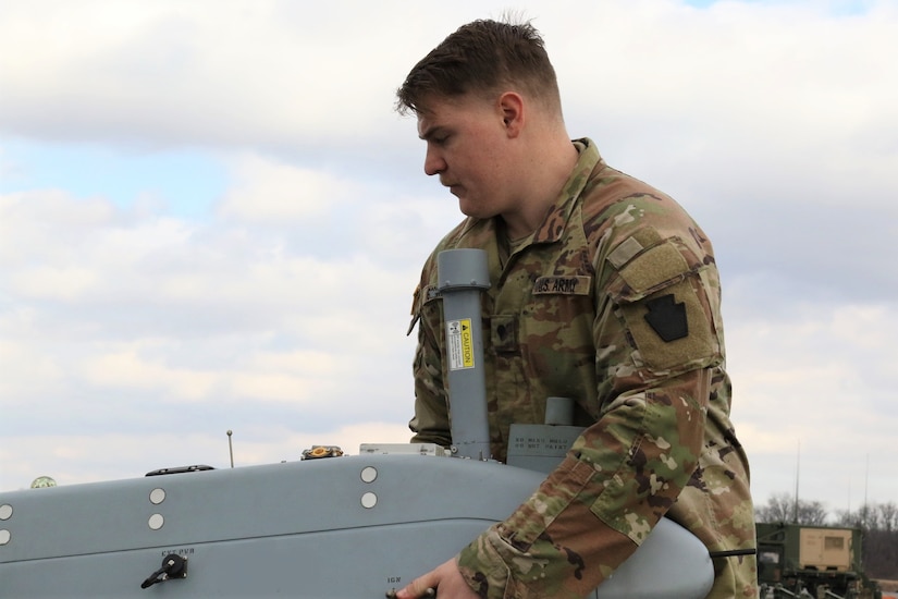 U.S. Army Spc. Hunter Goschinski, a UAS operator with Delta Company, 876th Brigade Engineer Battalion, 2nd Infantry Brigade Combat Team, 28th Infantry Division, prepares an RQ-7 Shadow for flight at the Unmanned Aircraft System Operations Facility at Fort Indiantown Gap, Jan. 30, 2023. (U.S. Army National Guard photo by Capt. Travis Mueller)