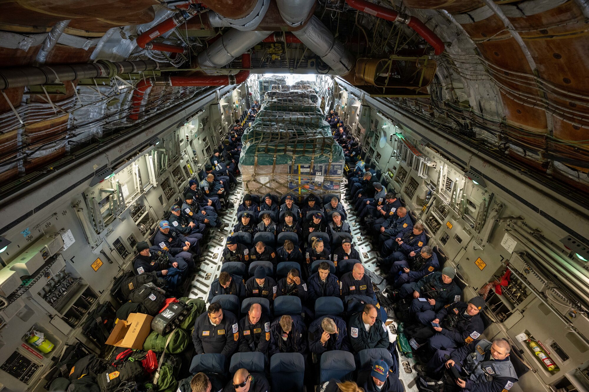 Urban Search and Rescue members from Fairfax County, Virginia, are boarded onto a C-17 Globemaster III on Dover Air Force Base, Delaware, Feb. 7, 2023. The U.S. Agency for International Development (USAID) is mobilizing emergency humanitarian assistance to respond to the devastating impacts in Türkiye following the worst earthquake to hit the region in almost a century. (U.S. Air Force photo by Senior Airman Faith Barron)