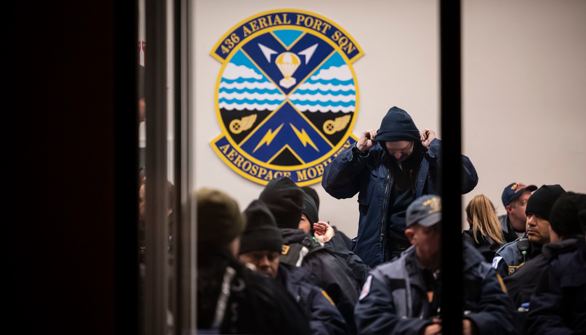 An Urban Search and Rescue member from Fairfax County, Virginia, puts on cold weather gear prior to boarding a C-17 Globemaster III on Dover Air Force Base, Delaware, Feb. 7, 2023. The U.S. Agency for International Development (USAID) is mobilizing emergency humanitarian assistance to respond to the devastating impacts in Türkiye following the worst earthquake to hit the region in almost a century. (U.S. Air Force photo by Staff Sgt. Marco A. Gomez)