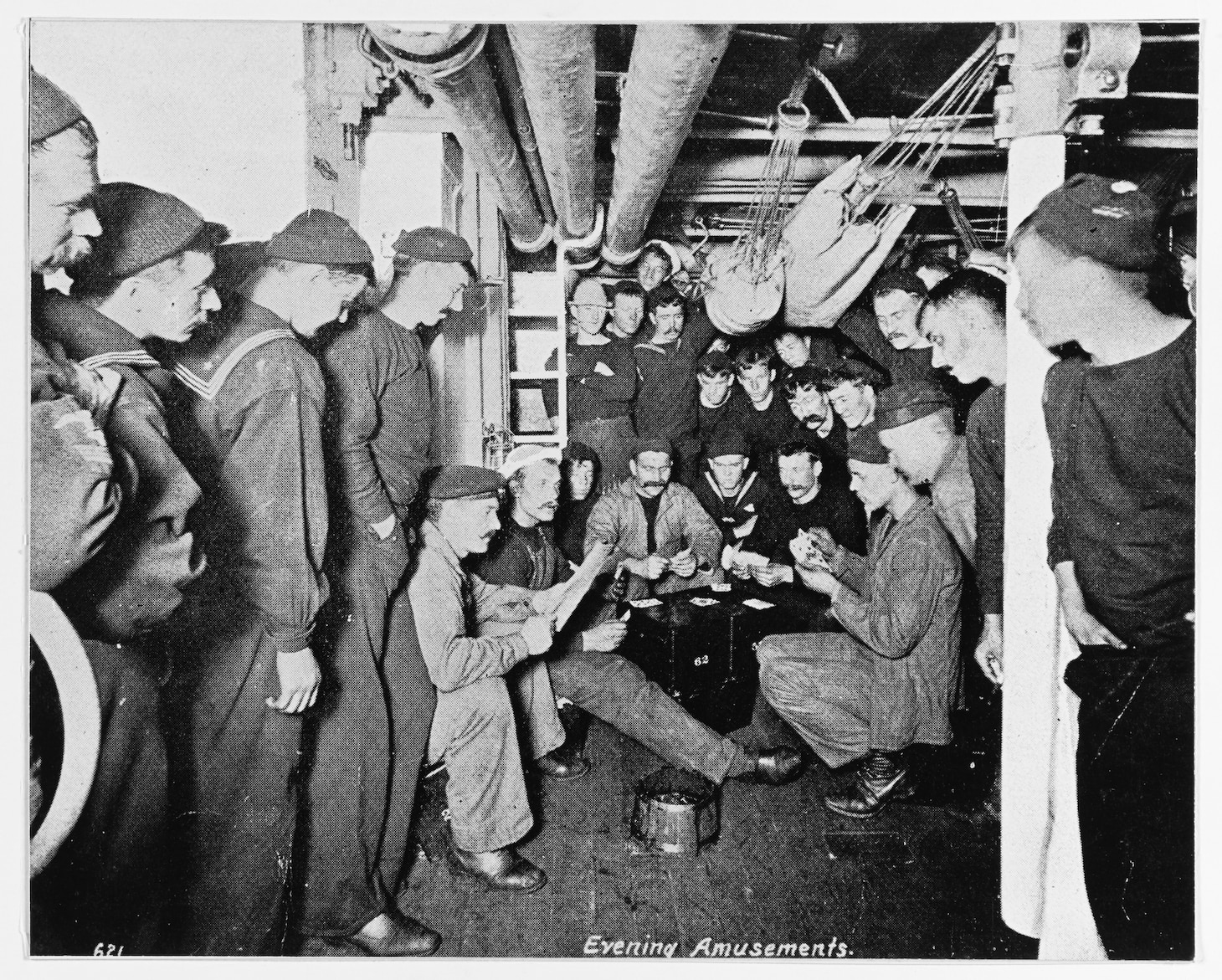 Evening Amusements: crewmembers playing cards and reading in their berthing spaces, circa 1895-1898. Halftone photograph, copied from the contemporary publication Uncle Sam's Navy, 1898. U.S. Naval History and Heritage Command Photograph.