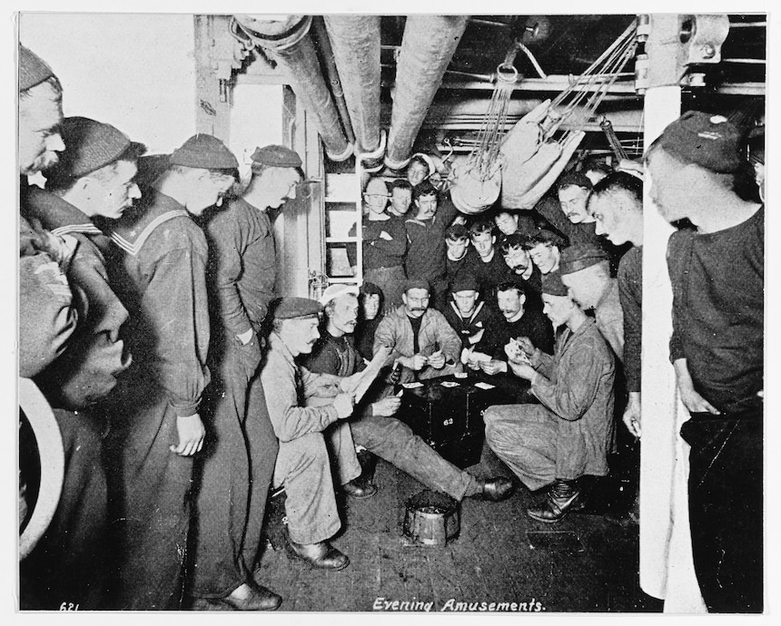 Evening Amusements: crewmembers playing cards and reading in their berthing spaces, circa 1895-1898. Halftone photograph, copied from the contemporary publication Uncle Sam's Navy, 1898. U.S. Naval History and Heritage Command Photograph.