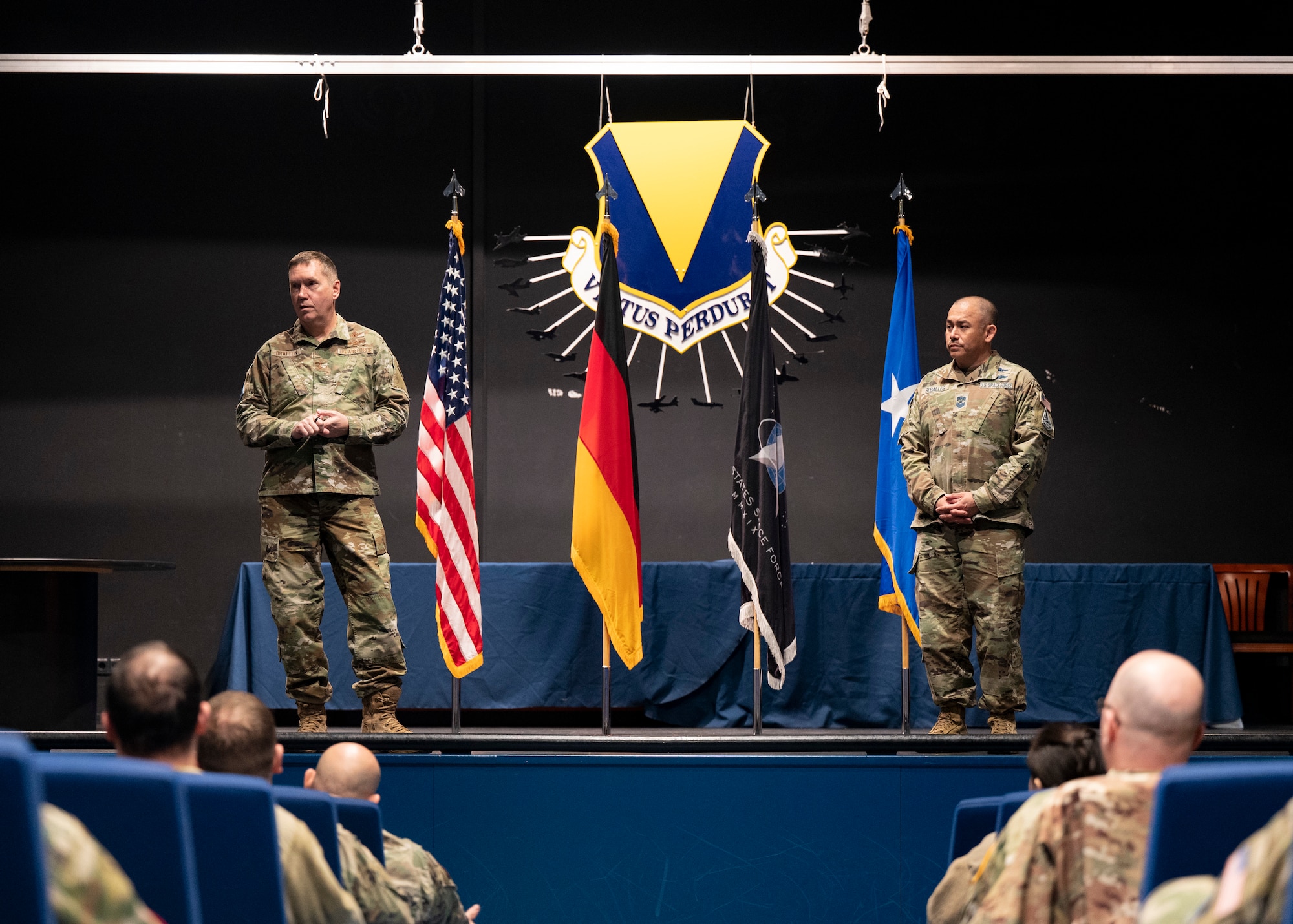 Maj. Gen. Shawn Bratton, commander of Space Training and Readiness Command, left, and U.S. Space Force Chief Master Sgt. James Seballes, senior enlisted leader of Space Training and Readiness Command, right speaks with Guardians and Airmen during an all-call at Ramstein Air Base, Germany, Feb. 1, 2023. During the all-call, Bratton and Seballes, met with and heard from Guardians and Airmen executing and supporting space operations in the U.S. European Command area of responsibility. (U.S. Air Force photo by 1st Lt. Charles Rivezzo)