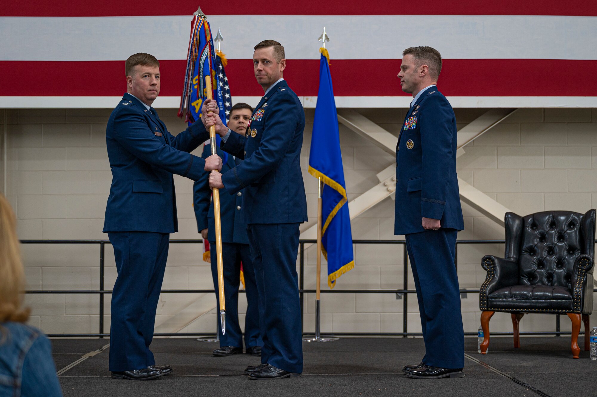 Col. John Poole, 317th Operations Group commander, takes the guidon from Lt. Col. Samuel Dunlap, outgoing 40th Airlift Squadron commander, during the 40th AS change of command ceremony at Dyess Air Force Base, Texas, Feb. 3, 2023. The 40th AS supports theater commanders' requirements with combat-delivery capability through tactical airland and airdrop operations as well as humanitarian efforts and aeromedical evacuation. (U.S. Air Force photo by Senior Airman Colin Hollowell)
