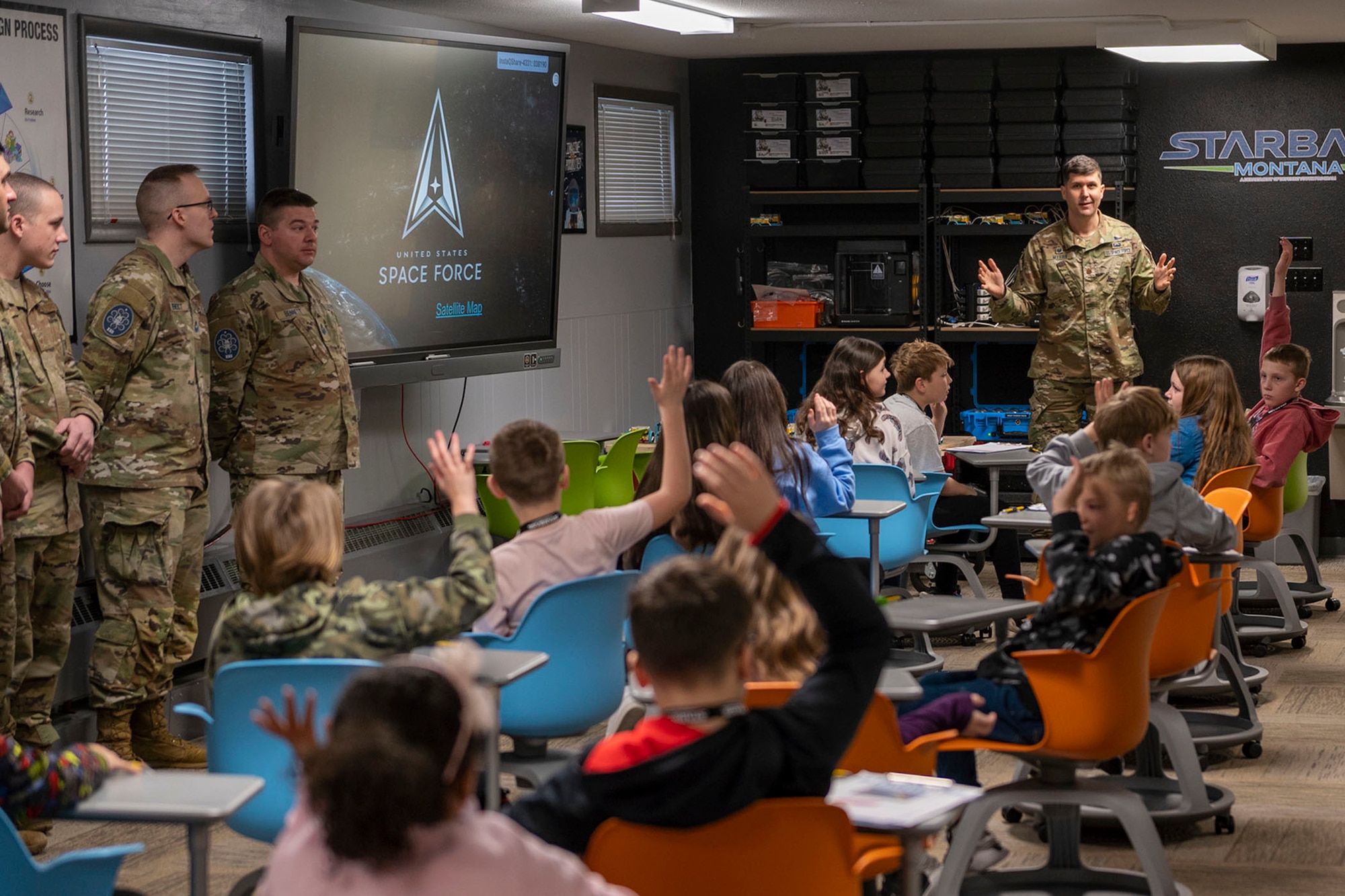 Maj. Jared Myers, right, 22nd Space Operations Squadron, Det 1 commander, speaks to a local elementary school class attending a STARBASE STEM class, at the Montana Air National Guard Base, Great Falls Montana, Feb. 2, 2023. STARBASE is the premiere Department of Defense science, technology, engineering and math program, offering 25-hours of education to 5th graders across the country. (U.S. Air Force photo by Airman 1st Class Elijah Van Zandt)